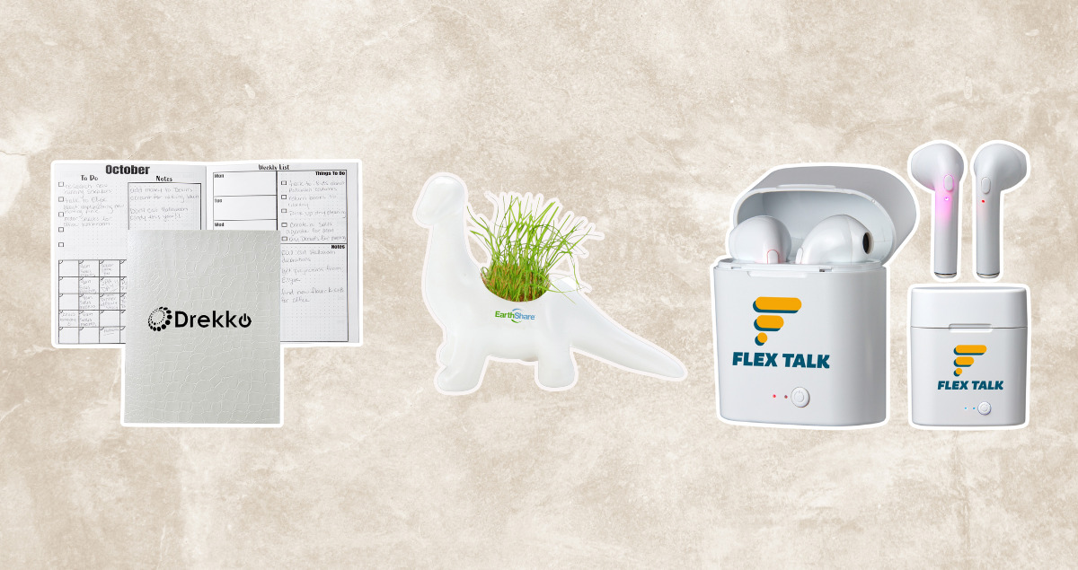 beige background with a planner, earbuds and a dinosaur planter